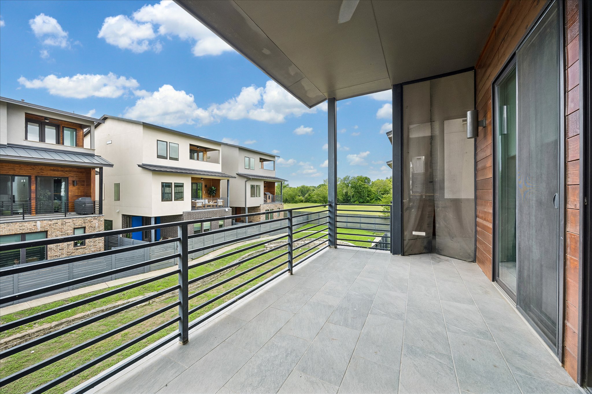 5006 Pecan Springs Road, Unit 6 Austin, TX 78723 - Photo 28 of 30 An inviting private patio balcony offers open-air living with sweeping greenbelt views.