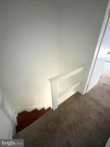 a view of wooden floor and a window in a room