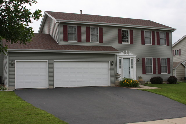 2826 Weld Road Elgin, IL 60124 - Photo 1 of 19 a front view of a house with a garden