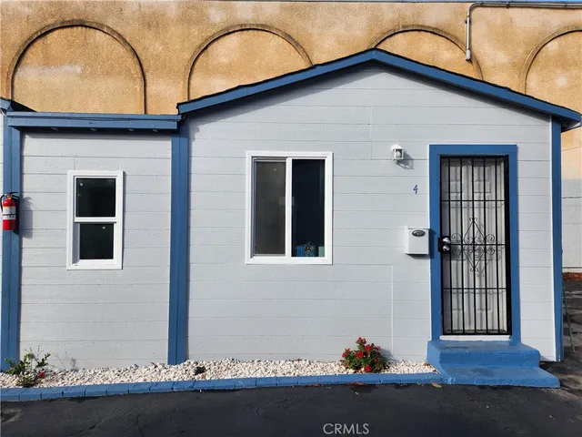 a view of wooden floor and a chandelier fan in a room