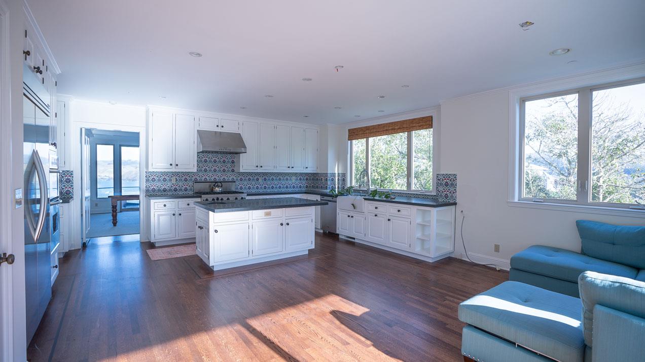 189 Kent Road Pacifica, CA 94044 - Photo 7 of 15 a kitchen with stainless steel appliances granite countertop wooden floors a stove a sink and a window