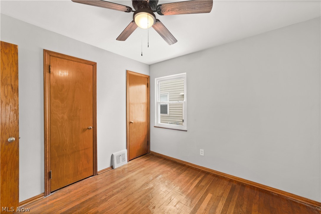 4907 Ridge Road Cleveland, OH 44144 - Photo 18 of 36 Unfurnished bedroom featuring ceiling fan, light hardwood / wood-style floors, and a closet