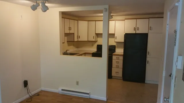 a view of kitchen with wooden cabinets