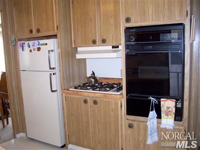 259 Ricardo Avenue, Unit 259 Santa Rosa, CA 95407 - Photo 6 of 12 a white refrigerator freezer and a stove sitting inside of a kitchen