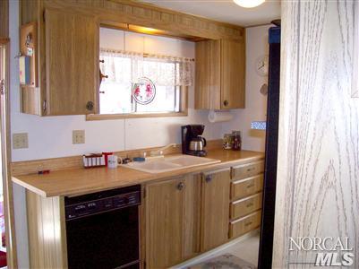 259 Ricardo Avenue, Unit 259 Santa Rosa, CA 95407 - Photo 7 of 12 a kitchen with a sink stove and cabinets