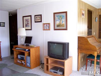 259 Ricardo Avenue, Unit 259 Santa Rosa, CA 95407 - Photo 8 of 12 a room with furniture and a flat screen tv