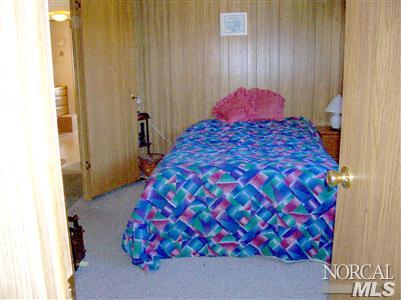 259 Ricardo Avenue, Unit 259 Santa Rosa, CA 95407 - Photo 10 of 12 a bedroom with a bed and a painting on the wall