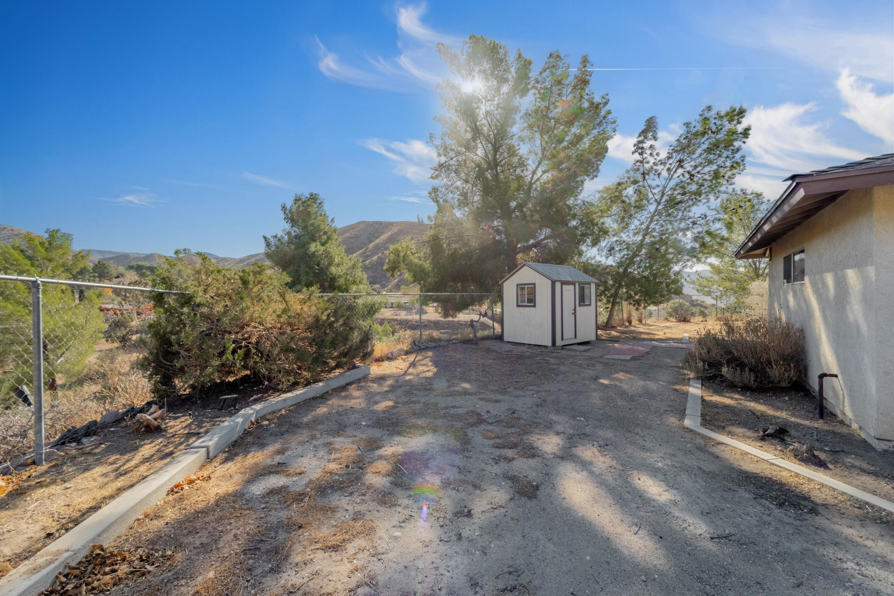 31427 Indian Oak Road Acton, CA 93510 - Photo 24 of 30 a backyard of a house with table and chairs under an umbrella