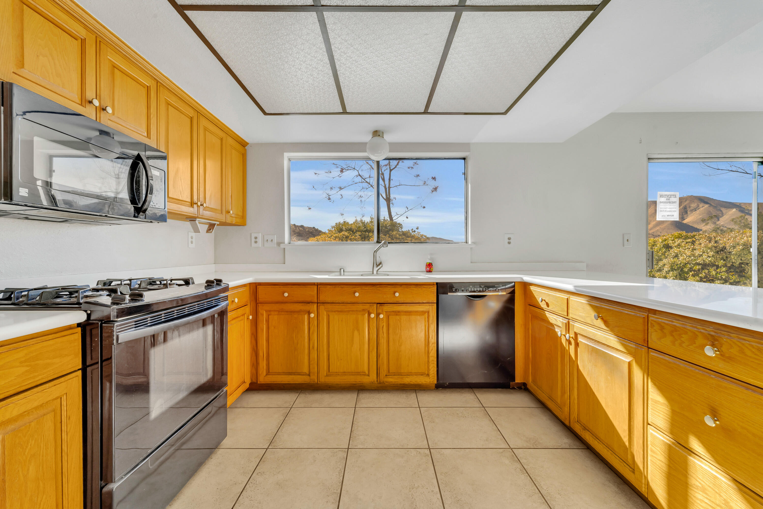 31427 Indian Oak Road Acton, CA 93510 - Photo 9 of 30 a kitchen with stainless steel appliances granite countertop a stove a sink and a microwave