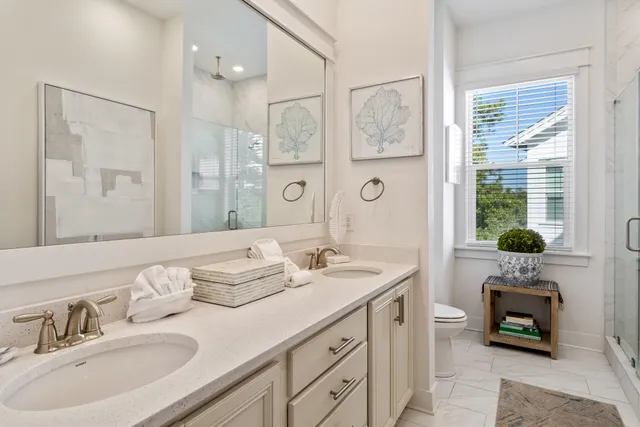 a spacious bathroom with sinks mirror and shower