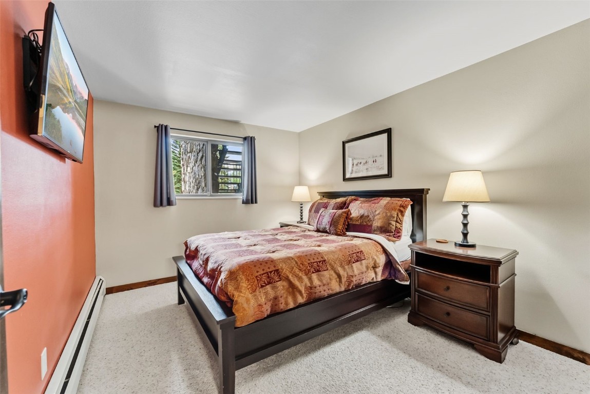 112 La Bonte Street, Unit 202 Dillon, CO 80435 - Photo 14 of 32 a bed room with a bed and a night stand