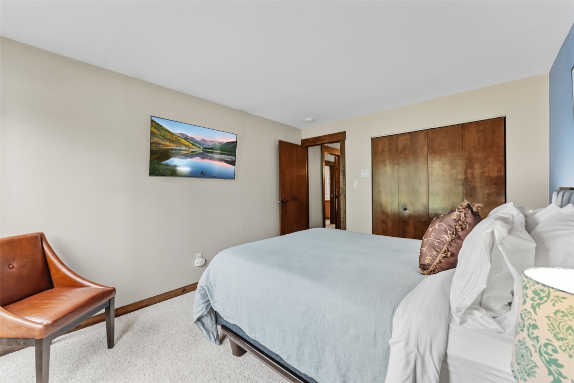 112 La Bonte Street, Unit 202 Dillon, CO 80435 - Photo 18 of 32 a bedroom with a bed and a couch