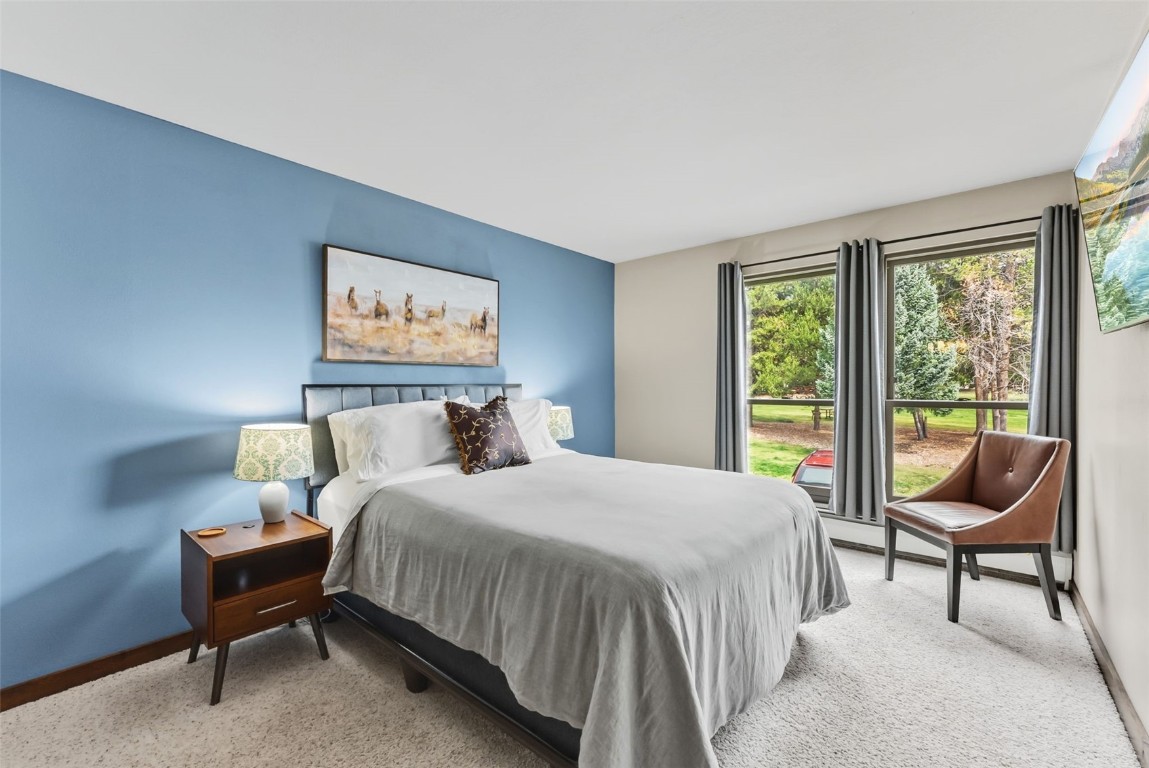 112 La Bonte Street, Unit 202 Dillon, CO 80435 - Photo 19 of 32 a bedroom with a bed and a large window