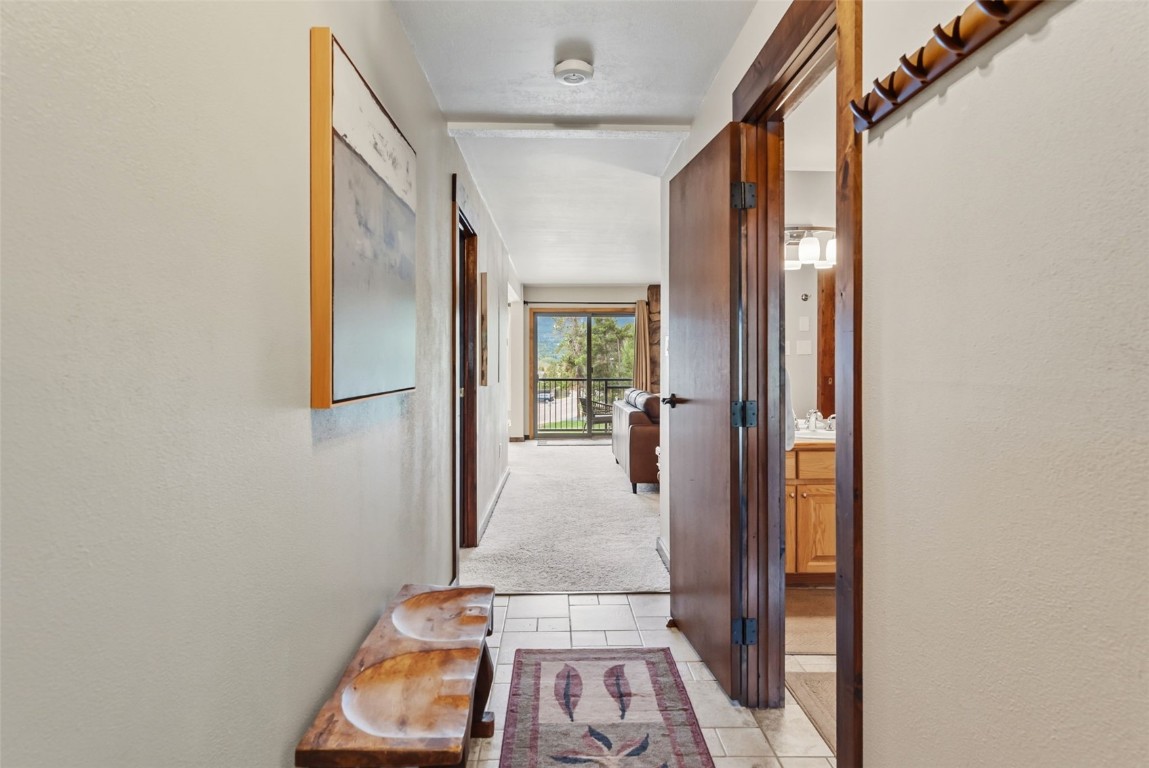 112 La Bonte Street, Unit 202 Dillon, CO 80435 - Photo 22 of 32 a view of a hallway with wooden floor and a living room