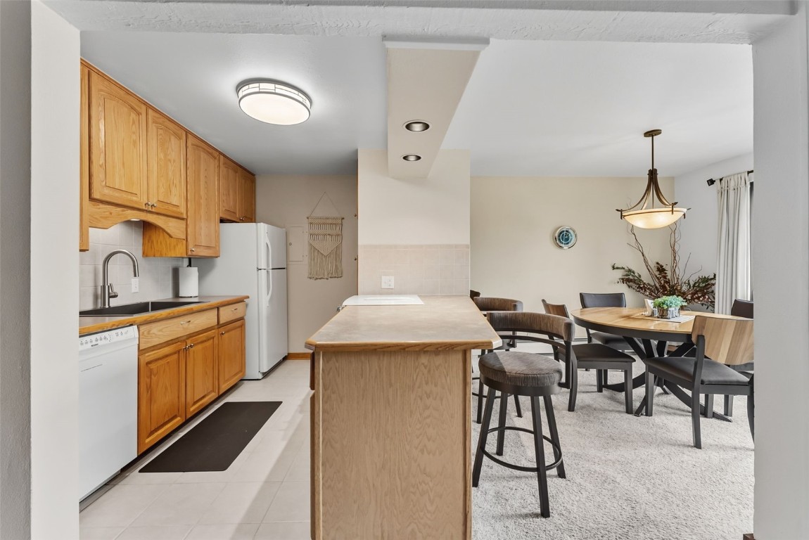112 La Bonte Street, Unit 202 Dillon, CO 80435 - Photo 6 of 32 a kitchen with a table chairs stove and refrigerator