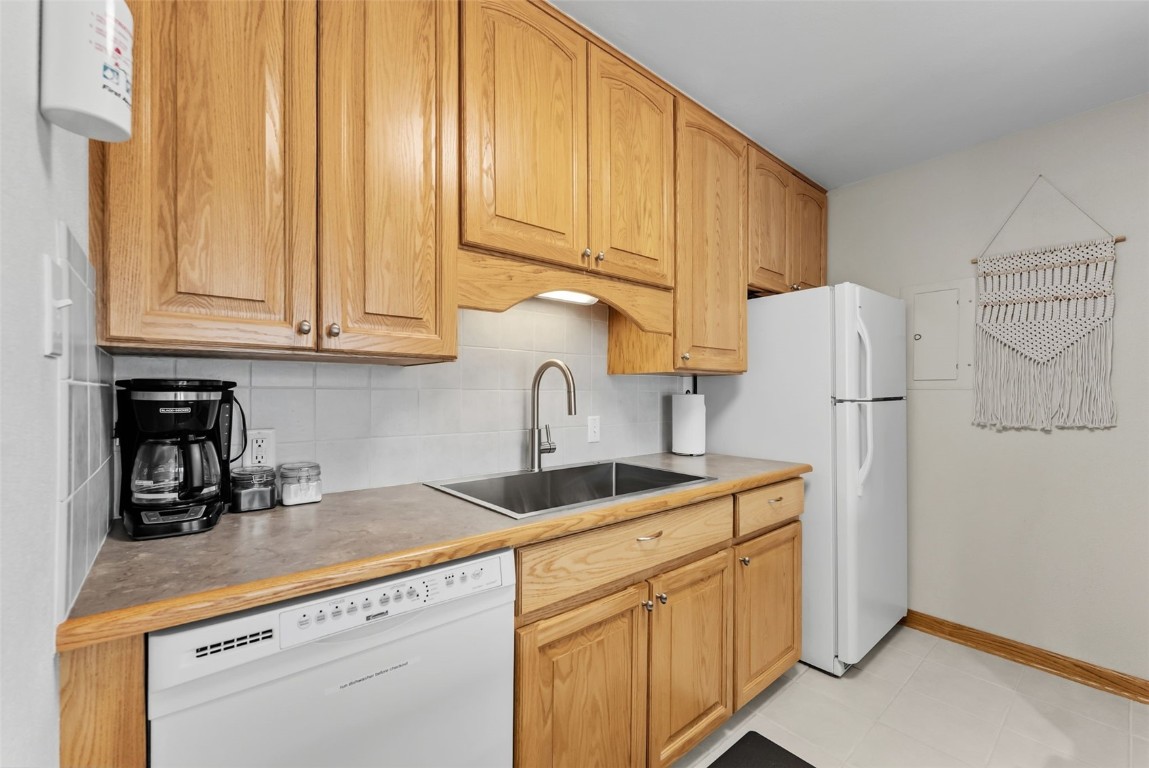 112 La Bonte Street, Unit 202 Dillon, CO 80435 - Photo 7 of 32 a kitchen with kitchen island a sink a refrigerator and cabinets