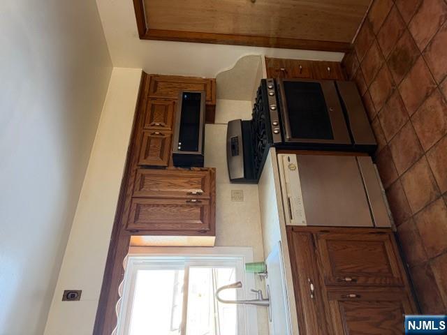 282-284 Washington Street, Unit 2 Fairview, NJ 07022 - Photo 4 of 6 a kitchen with stainless steel appliances granite countertop a stove a sink and a microwave