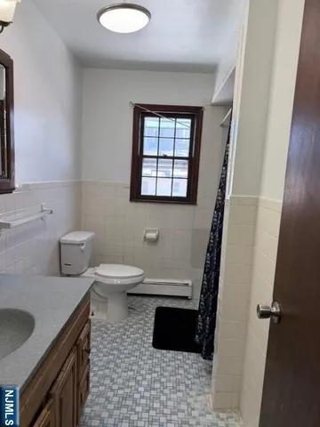 a bathroom with a sink a toilet and a window