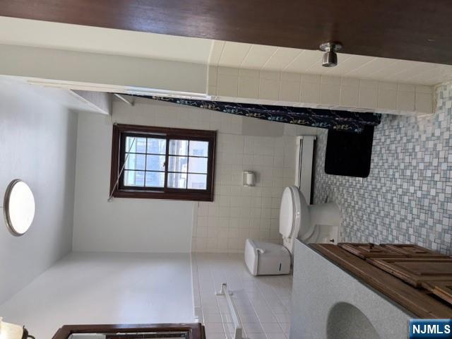 282-284 Washington Street, Unit 2 Fairview, NJ 07022 - Photo 6 of 6 a bathroom with a sink a toilet and a window