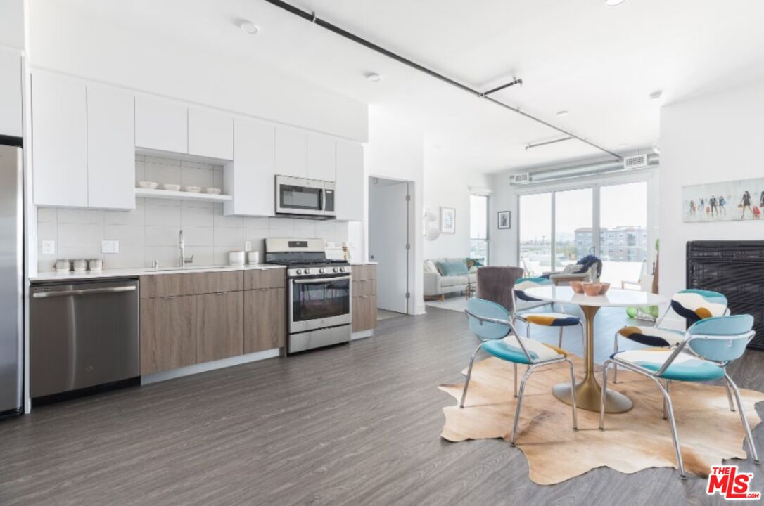 4210 Del Rey Avenue, Unit 401 Marina del Rey, CA 90292 - Photo 8 of 10 a kitchen with a sink cabinets and wooden floor