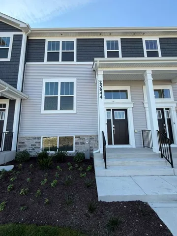 a view of a brick house with many windows