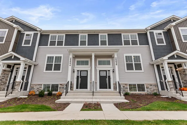 a view of a brick building next to a yard