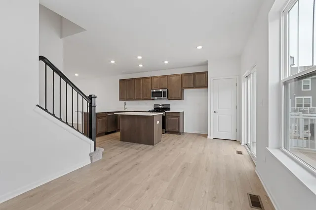 a view of kitchen with wooden floor and electronic appliances