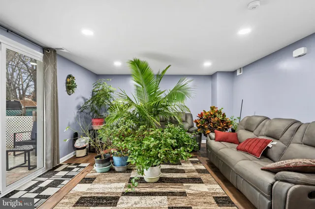 a living room with furniture potted plant and flowers