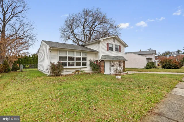 a house that has a big yard with large trees