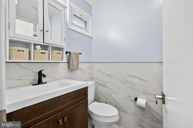 a bathroom with a sink a toilet and vanity