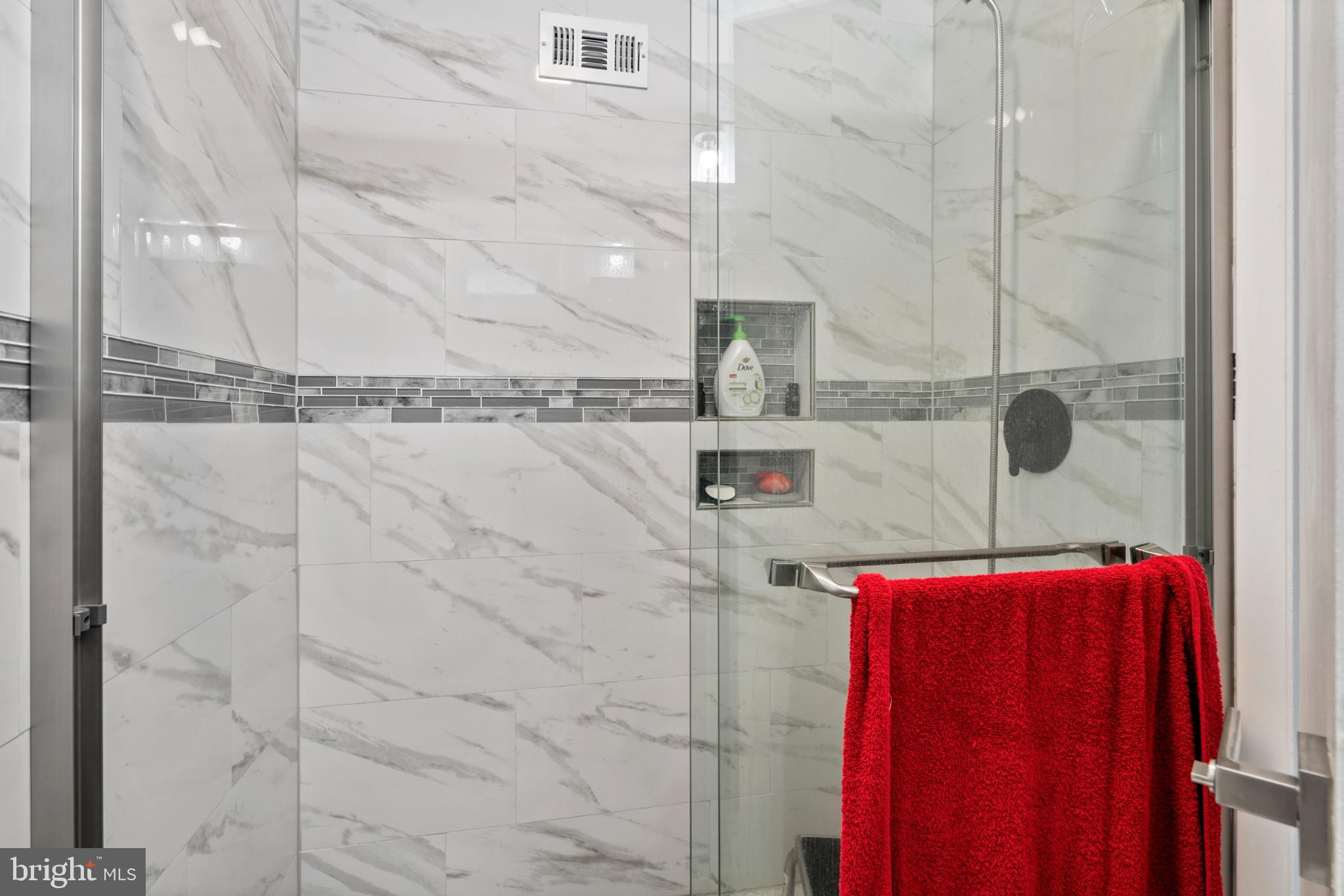 8912 Turton Drive Philadelphia, PA 19115 - Photo 23 of 34 Sleek shower with elegant marble tiles.