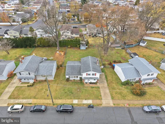 an aerial view of residential houses with outdoor space and lake view