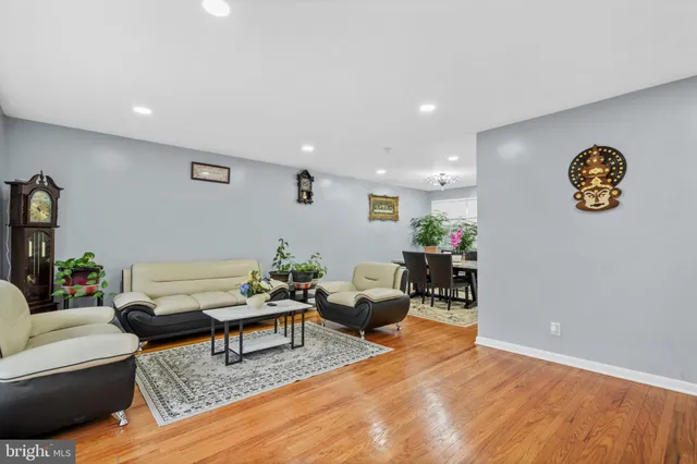 a living room with furniture and a table with wooden floor