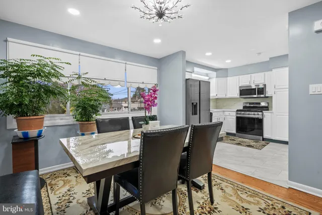 a view of a dining room with furniture and a kitchen