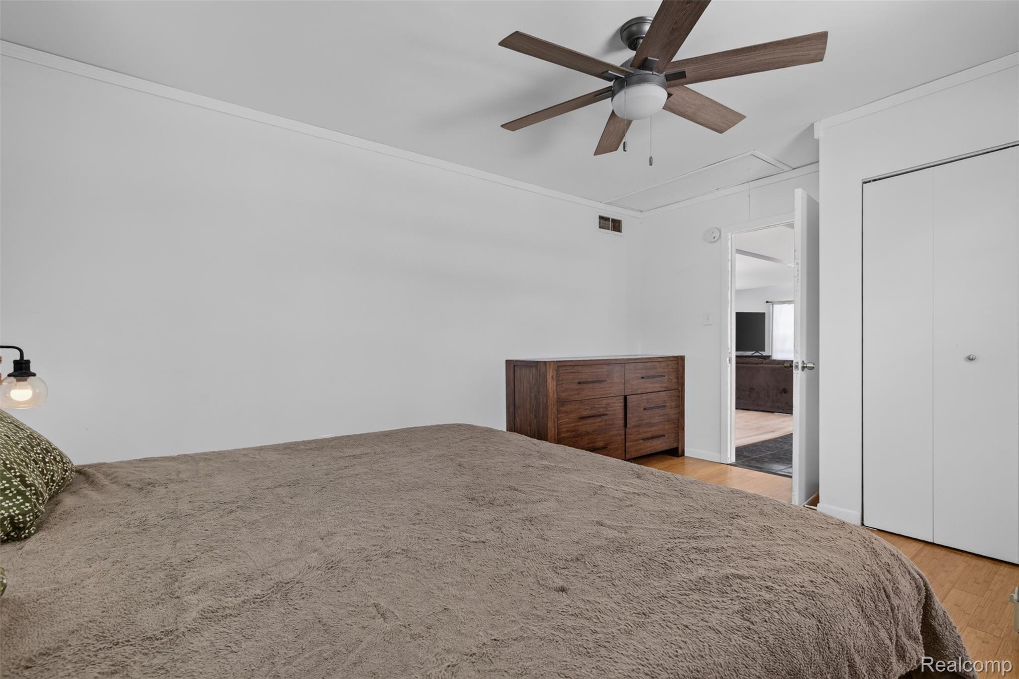 5244 Oleksyn Road Flint, MI 48504 - Photo 18 of 70 Interior room featuring wood-finish flooring, a ceiling fan with integrated lighting, and white walls