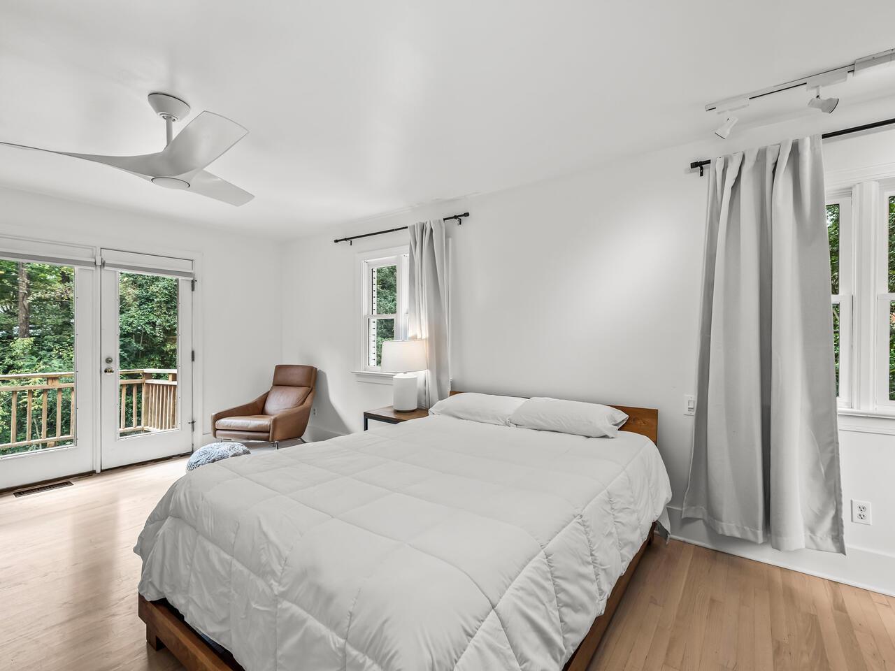 300 Dartmouth Road Raleigh, NC 27609 - Photo 13 of 28 a bedroom with a bed next to a window with wooden floor