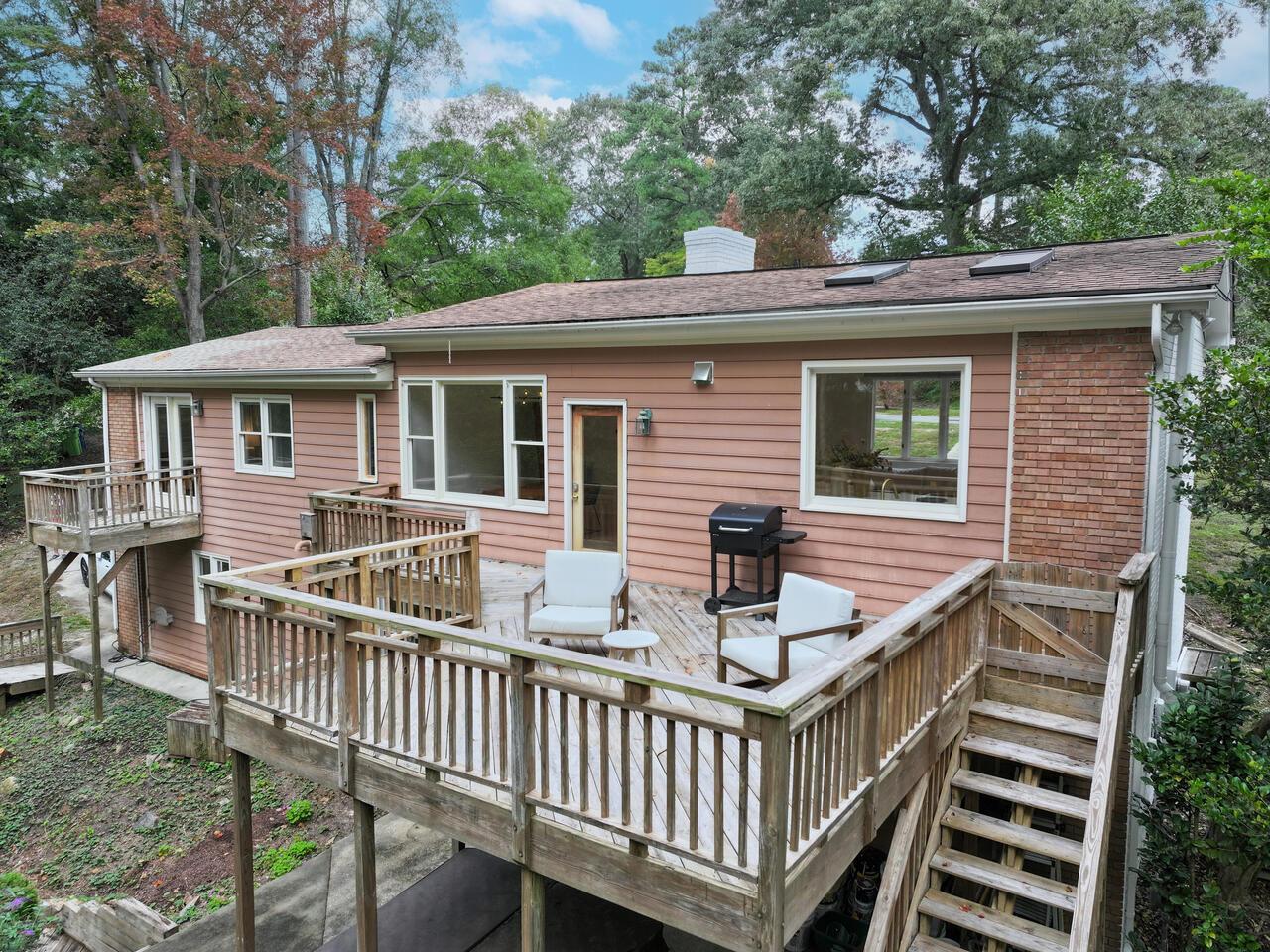 300 Dartmouth Road Raleigh, NC 27609 - Photo 27 of 28 a view of a house with wooden deck and furniture