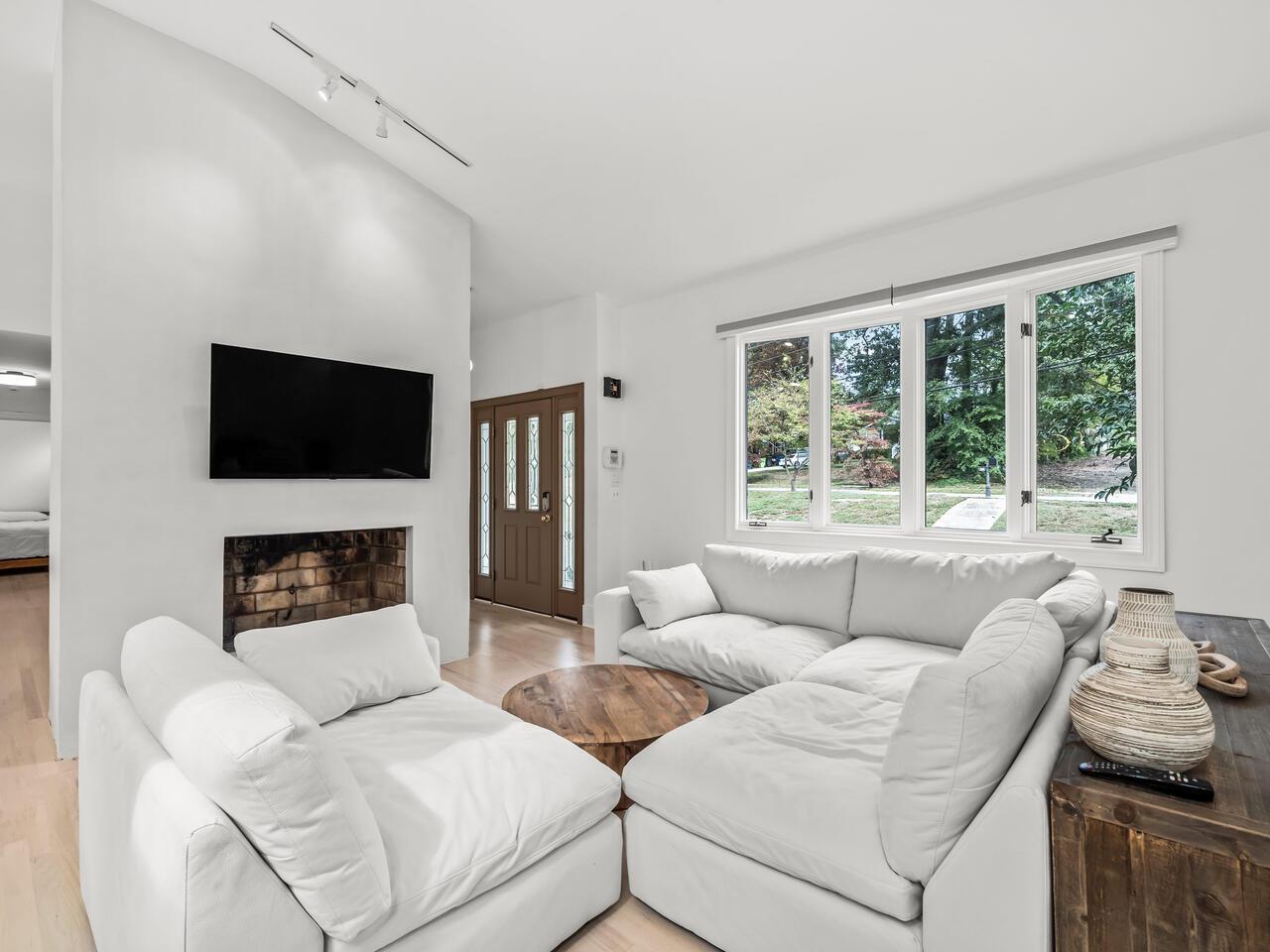 300 Dartmouth Road Raleigh, NC 27609 - Photo 6 of 28 a living room with furniture a fireplace and a flat screen tv