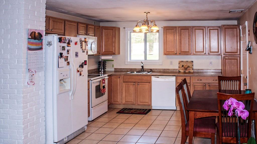 78 Michael Road Raynham, MA 02767 - Photo 11 of 42 a kitchen with stainless steel appliances a sink a stove a refrigerator and cabinets