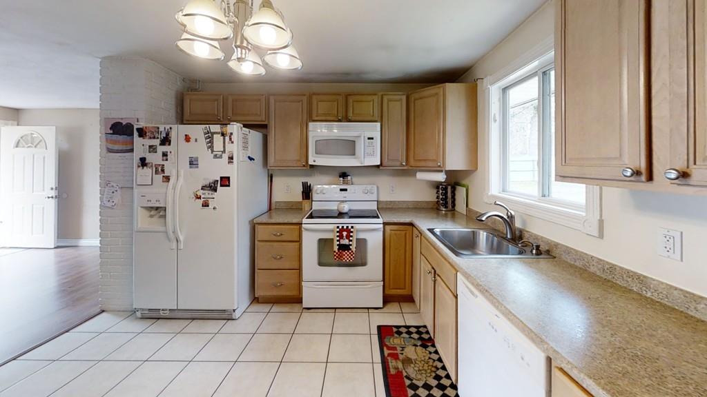 78 Michael Road Raynham, MA 02767 - Photo 14 of 42 a kitchen with a stove a sink and a refrigerator