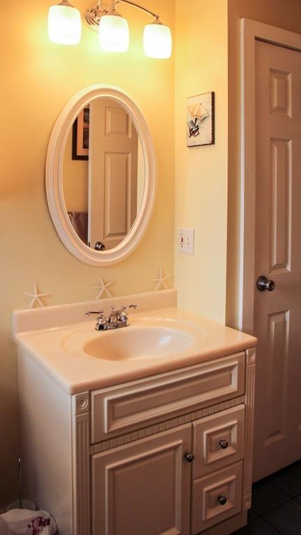 78 Michael Road Raynham, MA 02767 - Photo 24 of 42 a bathroom with a sink a toilet and mirror