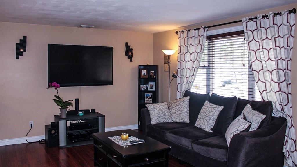 78 Michael Road Raynham, MA 02767 - Photo 9 of 42 a living room with furniture and a flat screen tv