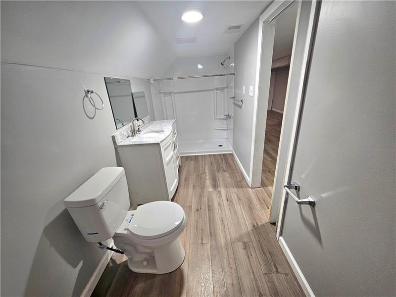 418 Short Street Donora, PA 15033 - Photo 11 of 12 a white toilet sitting next to a small bathroom sink and a mirror