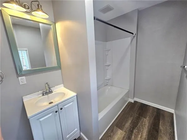 a bathroom with a bathtub and a sink