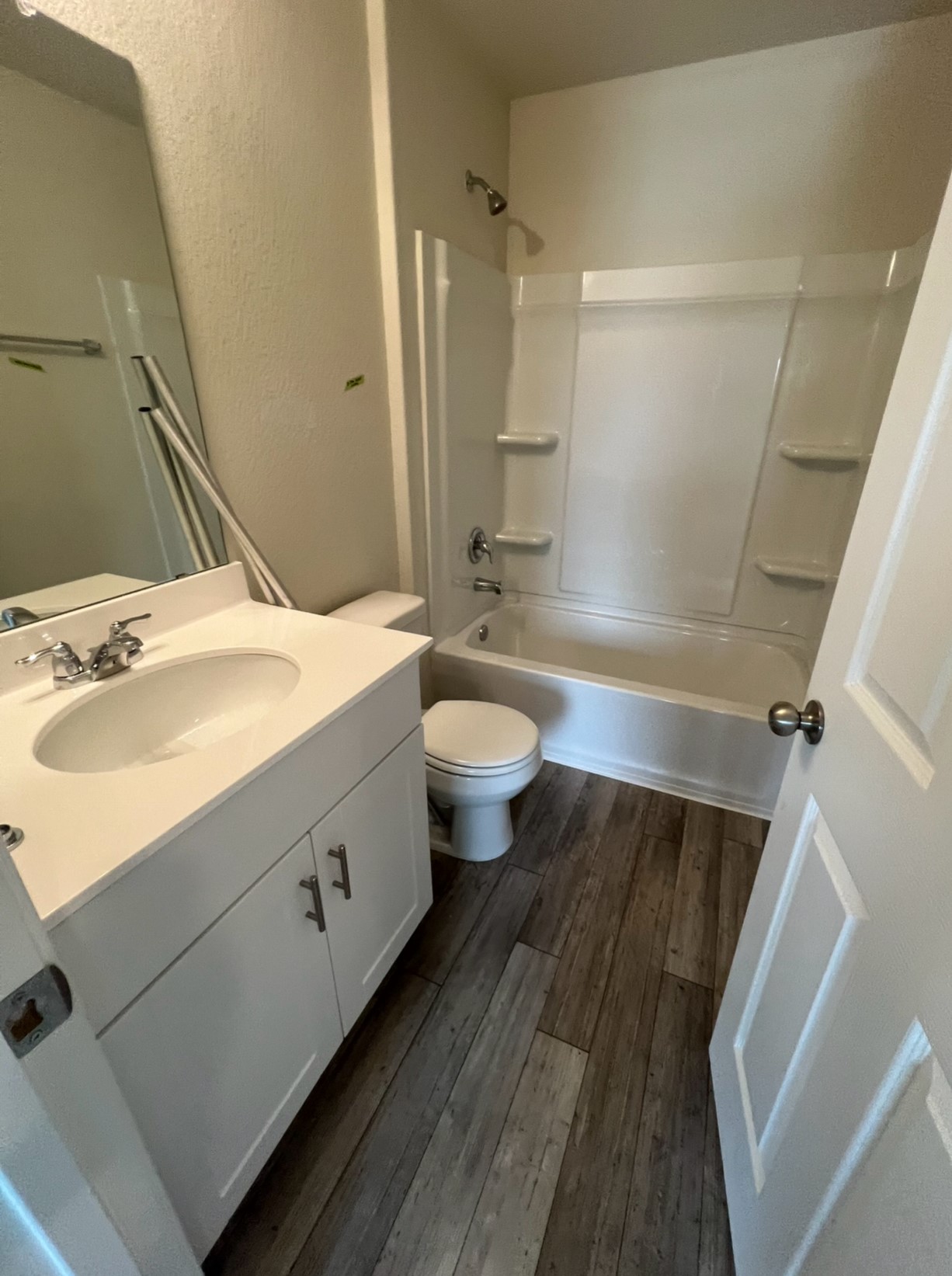 499 Tree Nut Loop Buda, TX 78610 - Photo 20 of 33 Hall bath features a single vanity, chrome fixtures, a standard toilet, and a combined tub and shower.