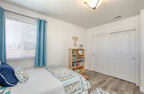 a view of room with baby crib and toys