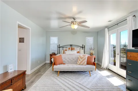 a bedroom with a bed couch and window