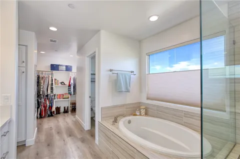 a bathroom with a tub sink and mirror