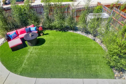 a view of a house with a yard and a patio