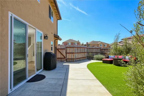 a front view of a house with a yard and potted plants